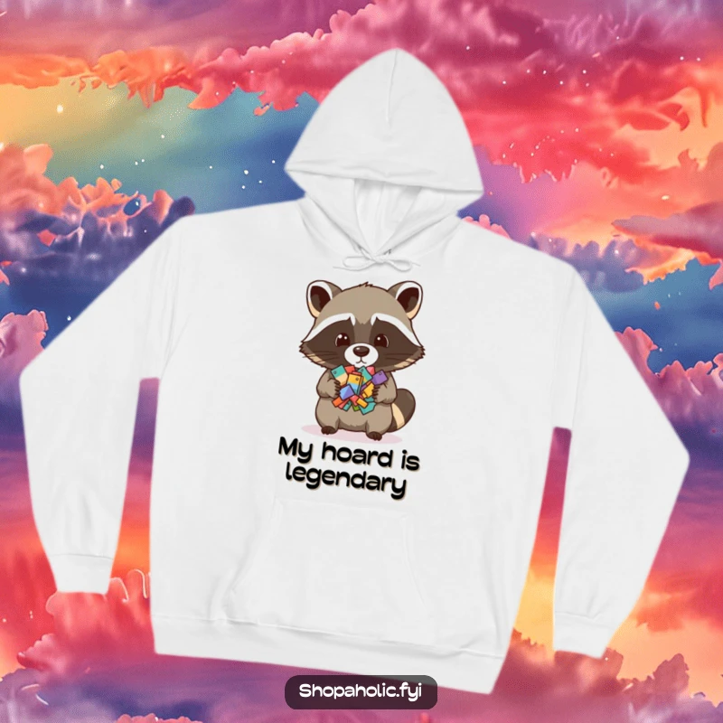 Funny hoodie featuring a raccoon proudly holding an assortment of tiny objects, perfect for cozying up with a sense of humor.