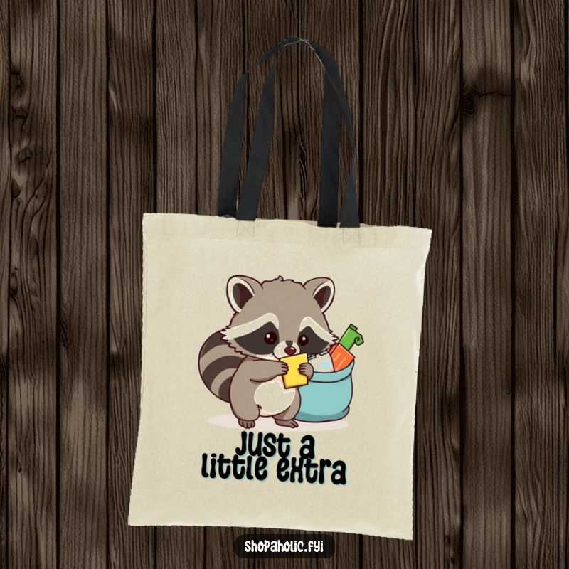 Funny raccoon tote bag featuring a mischievous raccoon cunningly placing an item into an already full bag, embracing abundance.